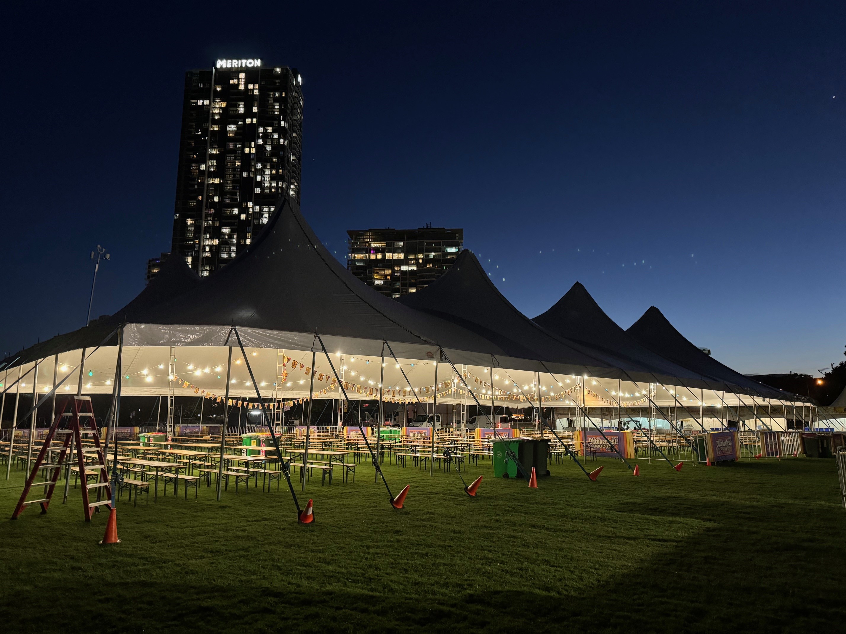 An Oktoberfest build at dusk with festoon lighting and bench seating