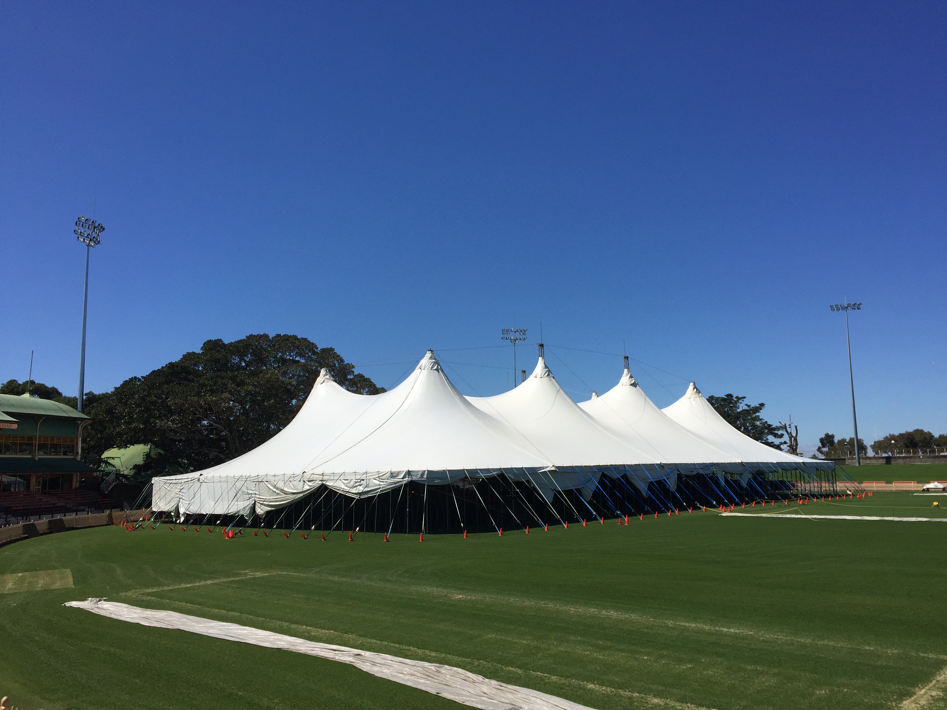 A Regal event tent built across a sports oval under clear sky